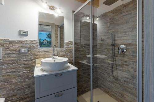 a bathroom with a sink and a shower at Residenza al Castello in Enguiso