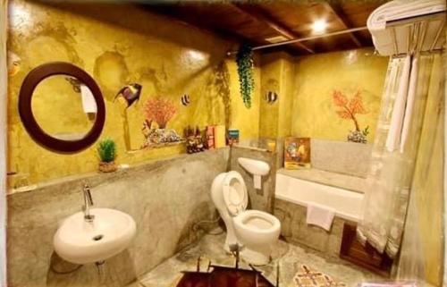 a bathroom with a sink and a toilet and a tub at The Colored House Jomtien in Jomtien Beach