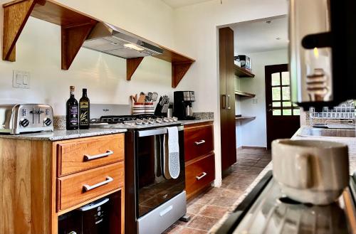 a kitchen with a stove top oven next to a counter at Wanakaset Panama in Dolega