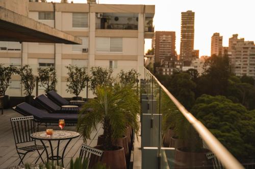 a balcony with a table and chairs on a building at Urbanica The Libertador Hotel in Buenos Aires