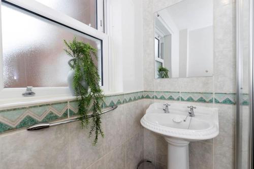 a bathroom with a sink and a mirror at In the heart of it! in Stokesley