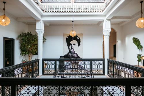 a view from the balcony of a house with a painting on the wall at RIAD DAR C in Marrakesh