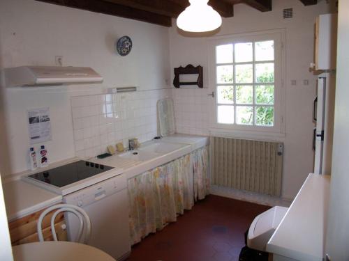 a white kitchen with a sink and a window at Maison Sauzon, 4 pièces, 6 personnes - FR-1-418-153 in Sauzon