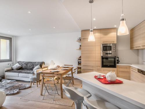 une cuisine et un salon avec une table et des chaises dans l'établissement Appartement 3 pièces au centre de Megève, balcon, proche télécabine, Wifi, idéal pour 4 personnes - FR-1-453-53, à Megève