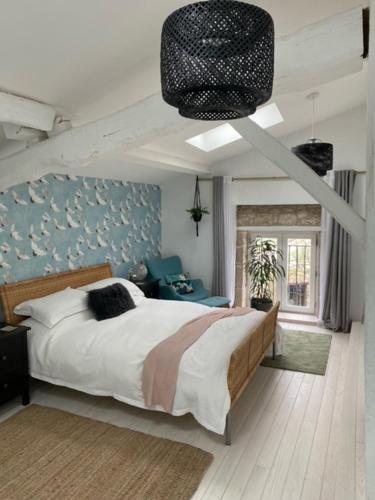 a bedroom with a large bed in a room at Figtrees in Margueron