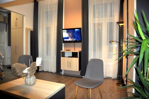 Televízia a/alebo spoločenská miestnosť v ubytovaní Angel's Apartman