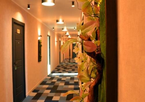 a hallway with a plant on the wall at Season Suite Apart-Hotel in Batumi