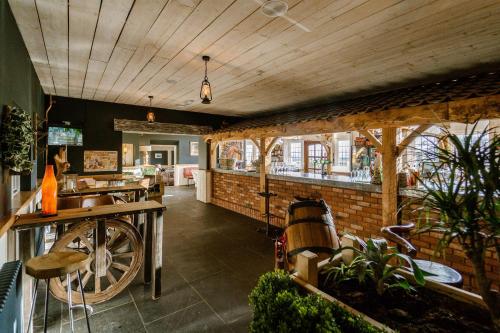 a restaurant with a wooden ceiling and a brick wall at Sneaton Castle in Whitby