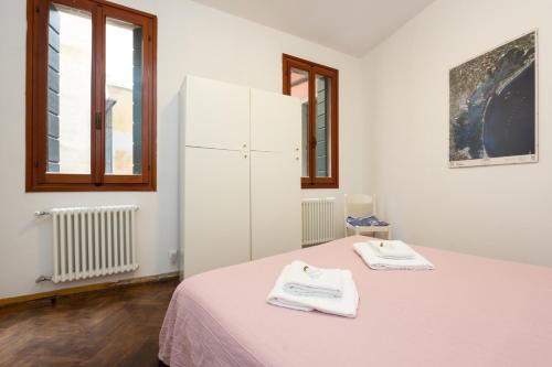 um quarto branco com uma cama e um frigorífico branco em Ca' Del Mercato em Veneza