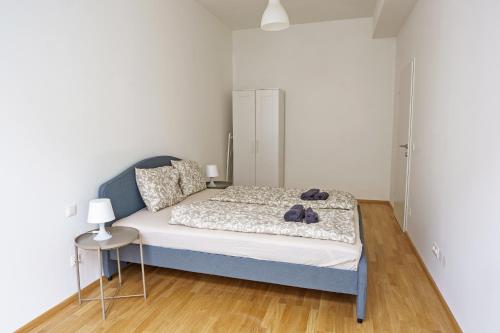 a bedroom with a bed and a table with a lamp at Vienna City Apartments Ottakring in Vienna