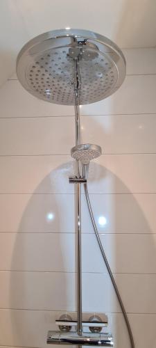 a silver lamp with a light on a ceiling at Marry's boshuisje in Dalfsen