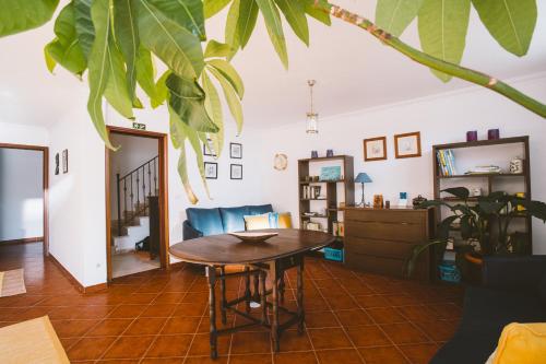 a living room with a table and a couch at Best Houses 31 - Seashell House in Baleal