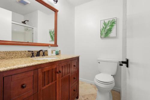 a bathroom with a toilet and a sink and a mirror at Fairway Dream - Sawgrass 2 Bedrooms - 2 Bath Villas Sleep 6, Close To Beach in Ponte Vedra Beach