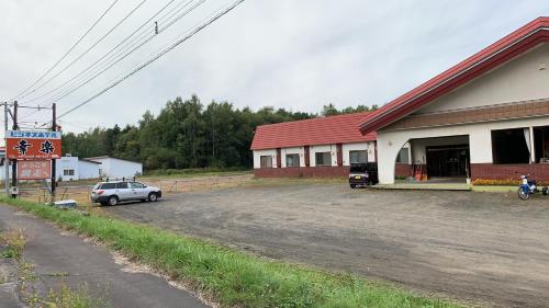 a car parked in a parking lot in front of a building at ビジネスホテル幸楽 in Abashiri
