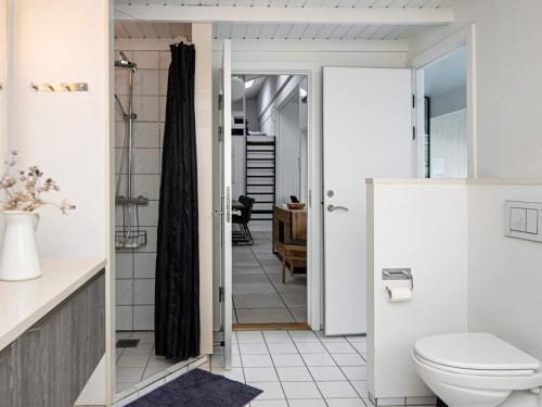 a bathroom with a toilet and a walk in shower at Three-Bedroom Holiday home in Knebel 23 in Knebel