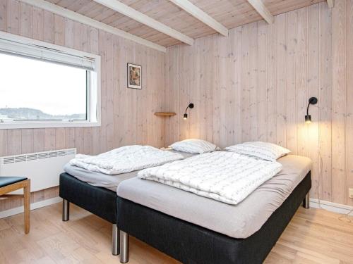 KnebelにあるThree-Bedroom Holiday home in Knebel 23のベッドルーム1室(ベッド2台、窓付)