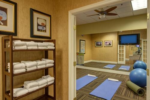 a room with a bunch of towels on shelves at The Rockville Hotel, a Ramada by Wyndham in Rockville