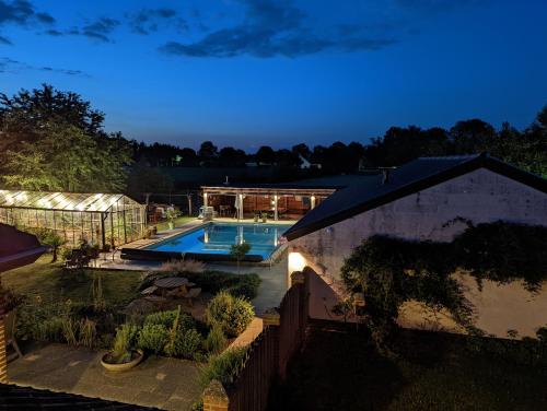 an aerial view of a house with a swimming pool at night at Appartement - B&B 'la bienvenue' in Venlo, Limburg in Venlo