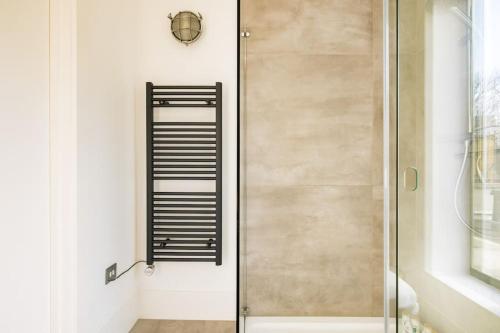 a shower with a glass door in a bathroom at Cool Loft in fashionable East London in London