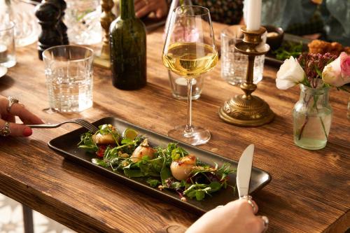 a table with a plate of food and a glass of wine at The Globe in Exeter