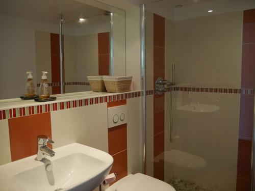 a bathroom with a sink and a shower and a toilet at Maison Sauzon, 5 pièces, 8 personnes - FR-1-418-23 in Sauzon