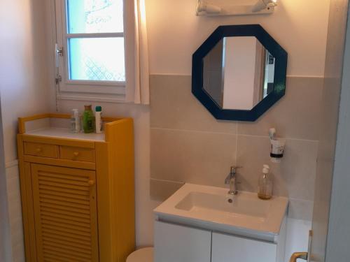 a bathroom with a sink and a mirror at Maison lumineuse avec jardin à Sauzon, proche plage - FR-1-418-70 in Sauzon