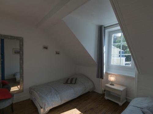 a small bedroom with a bed and a window at Appartement Le Palais, 4 pièces, 6 personnes - FR-1-418-58 in Le Palais