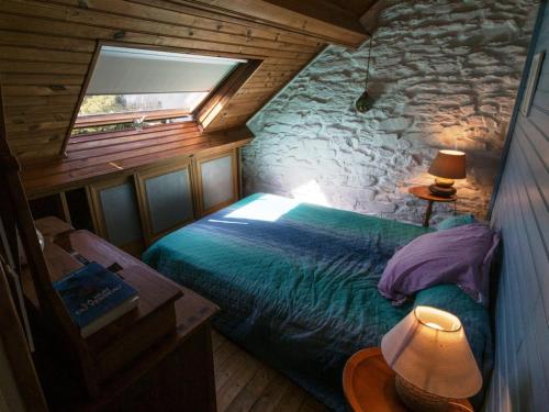 a bedroom with a bed in a log cabin at Appartement Le Palais, 3 pièces, 4 personnes - FR-1-418-83 in Le Palais