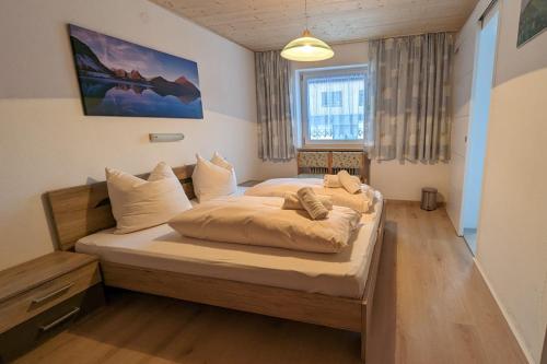 a bedroom with a large bed in a room at Gästehaus Wolf in Elbigenalp