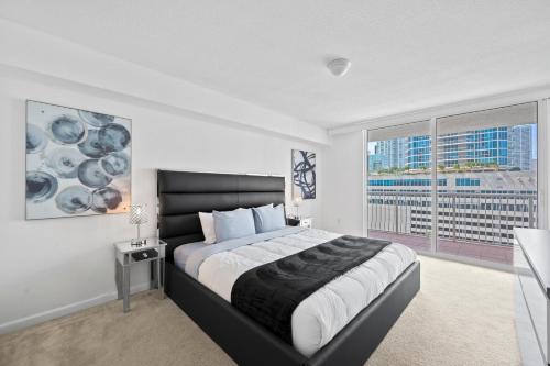 ein Schlafzimmer mit einem großen Bett und einem großen Fenster in der Unterkunft Private Unit Miami With Amenities And Parking in Miami