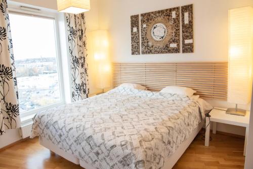 ein Schlafzimmer mit einem Bett und einem großen Fenster in der Unterkunft Wilde Guest Apartment Tigutorn in Tartu