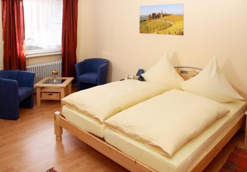 a bedroom with a large bed with pillows at Gasthaus Ochsen in Ortenberg