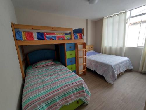 - une chambre avec deux lits superposés et un lit dans l'établissement L & P Apart Punta Hermosa, à Punta Hermosa