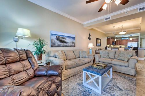 a living room with two couches and a table at Beachfront Dauphin Island Condo Pool Access! in Dauphin Island