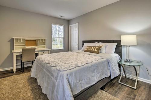 a bedroom with a bed and a desk and a table at Renovated Raleigh Home half Mi to Downtown! in Raleigh