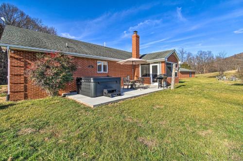 a brick house with a patio with a grill at Home with Hot Tub Near Shenandoah Natl Park! in Front Royal
