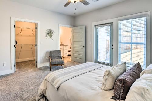 a bedroom with a bed and a chair at Opelika Townhome with Central AandC and Heating! in Opelika