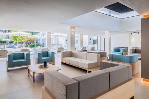 a lobby with couches and chairs and a table at Occidental Puerto Banús in Marbella