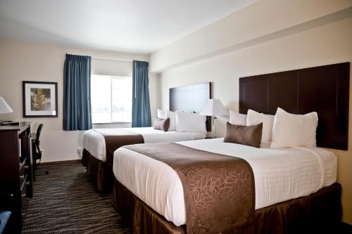a hotel room with two beds and a window at Cobblestone Inn & Suites -Clarinda in Clarinda