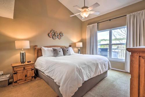 a bedroom with a bed with a ceiling fan and a window at Lakefront Home with Point Venture Golf Access! in Point Venture
