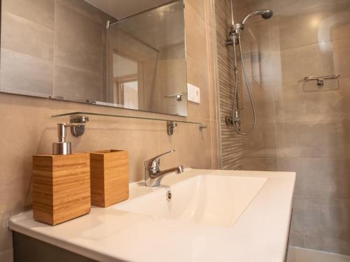 een badkamer met een witte wastafel en een spiegel bij Residencial Bia d'Olaf in Santa Maria