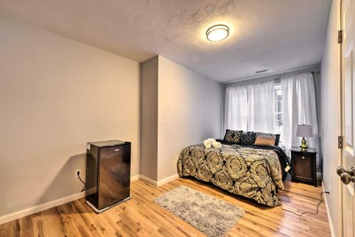 a bedroom with a bed and a television in front of a window at Worcester Vacation Rental with Ideal Location! in Worcester