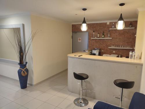 a kitchen with a counter and stools in a room at Angelus in Fátima