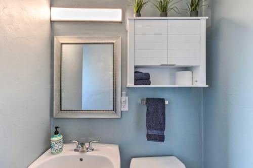 a bathroom with a sink and a mirror at Grand Junction Vacation Rental with Fire Pit! in Grand Junction