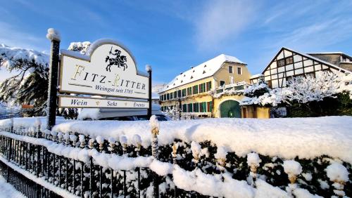 a sign in the snow in front of a building at Unterkunft im Weingut Fitz-Ritter in Bad Dürkheim