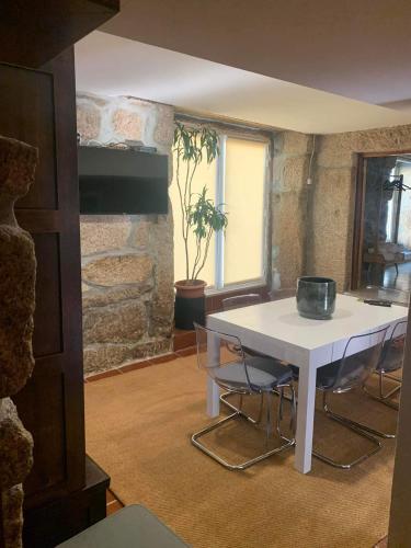 a white table and chairs in a room at Villa Candoso in Candoso