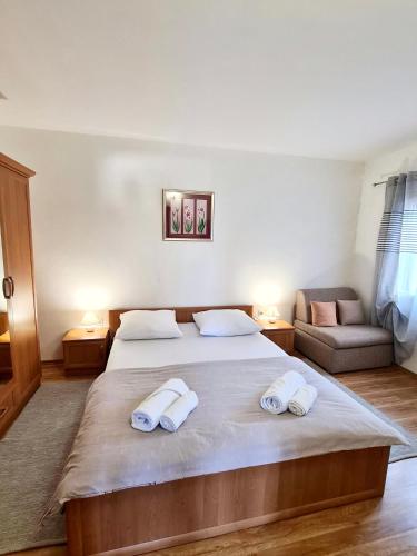 a bedroom with a large bed with two towels on it at Villa Sofija in Supetar