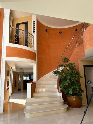 a staircase in a building with a plant at Villa The View in Villefranche-sur-Mer
