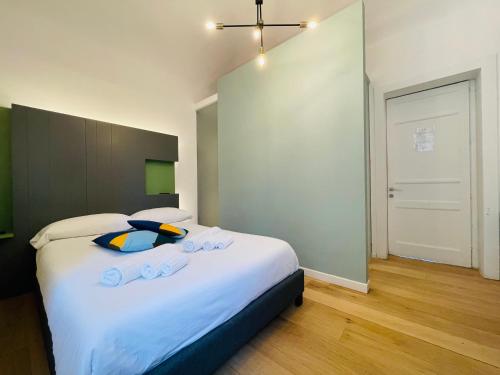 a bedroom with a large bed with white sheets at Dimora del Mercante in Catania