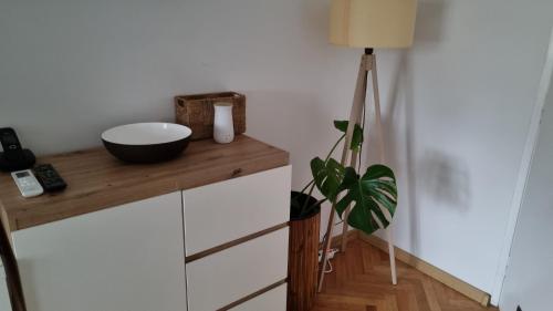 a room with a table with a bowl on top of it at Apartman Lumi in Čakovec